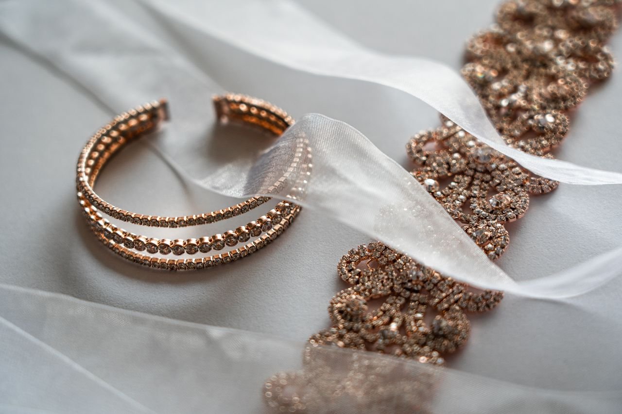 The Art of Drawing Readers In: Your attractive post title goes here Close-up of luxurious rose gold bracelet and lace, ideal for brides.